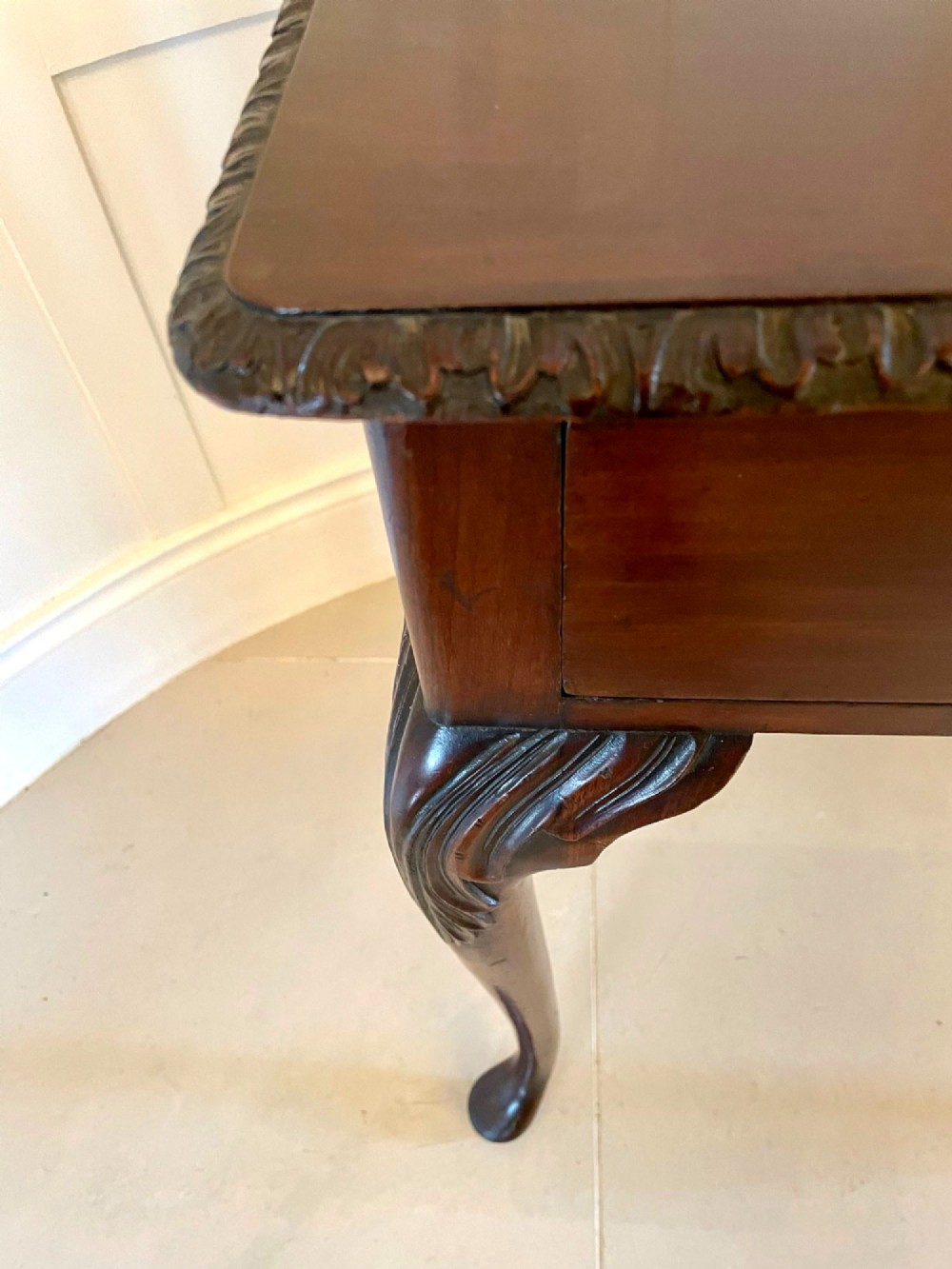 A George III mahogany side table featuring a rectangular top with carved moulding, a long drawer with brass handles, and cabriole legs. View IV
