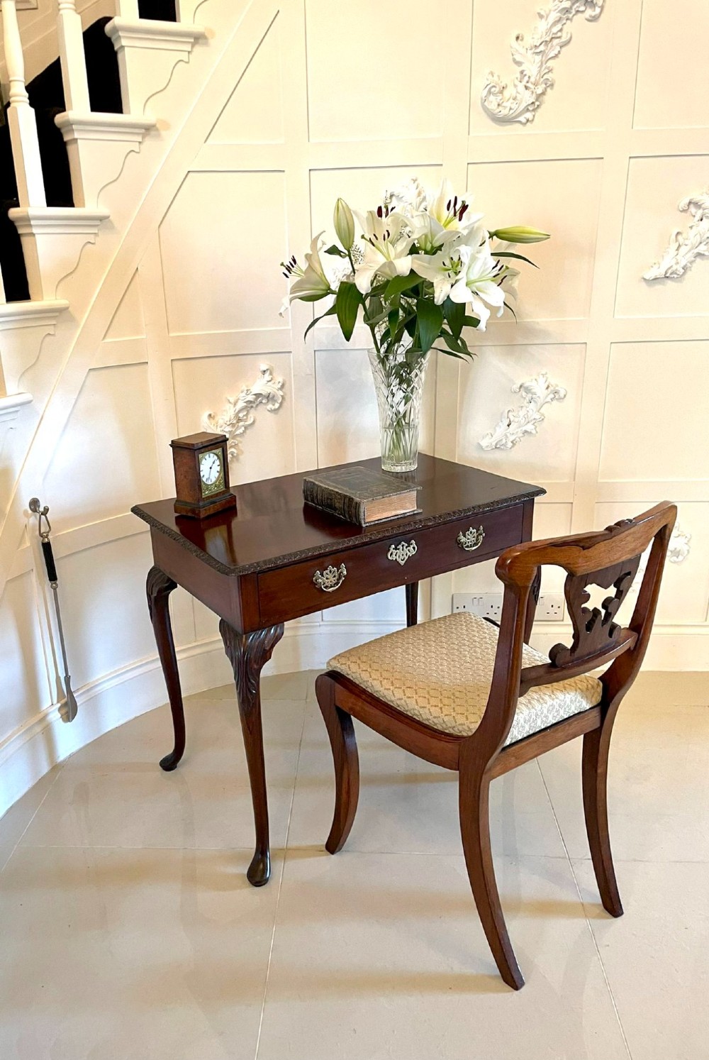 A George III mahogany side table featuring a rectangular top with carved moulding, a long drawer with brass handles, and cabriole legs. View V