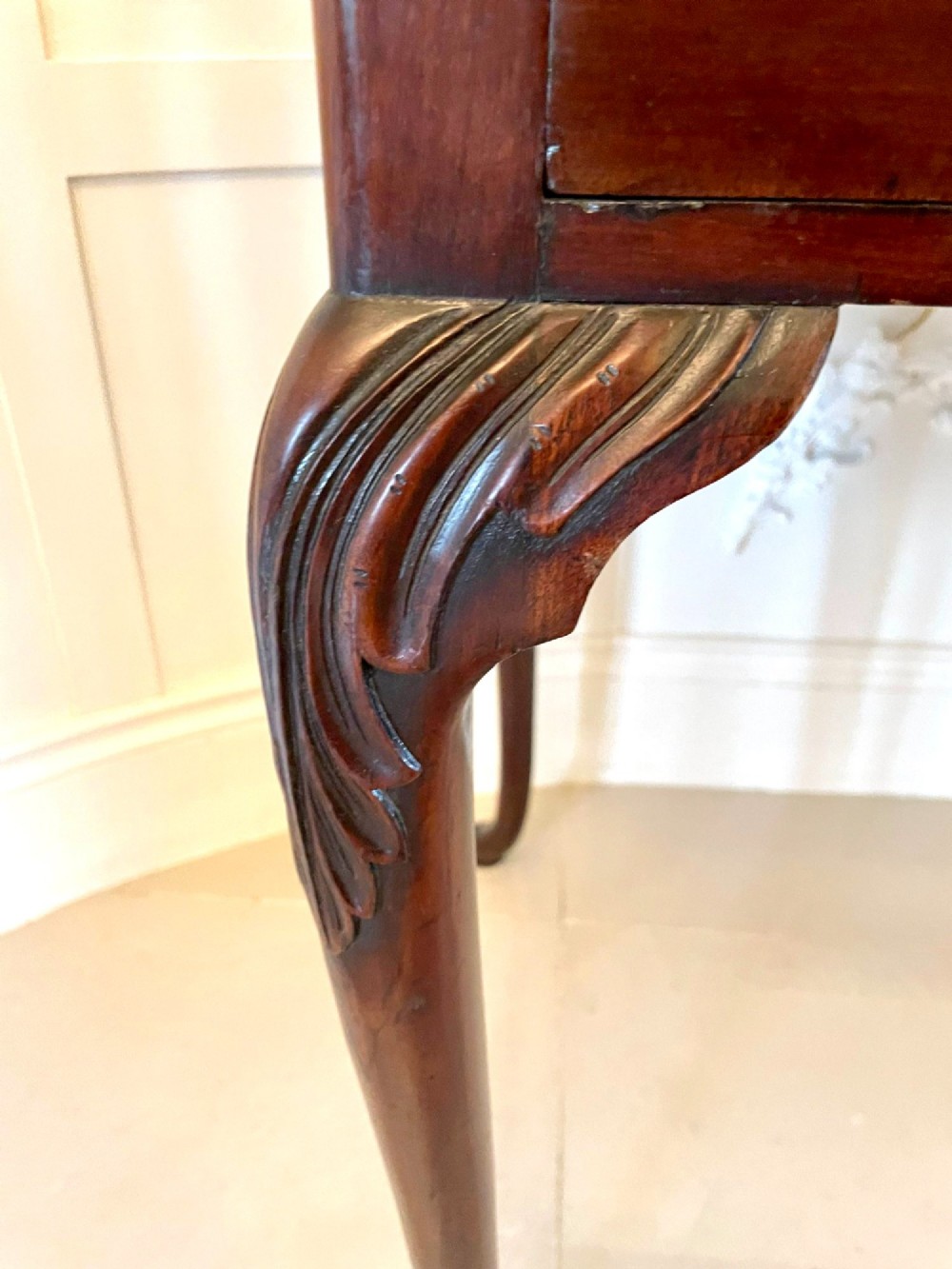 A George III mahogany side table featuring a rectangular top with carved moulding, a long drawer with brass handles, and cabriole legs. View VIII