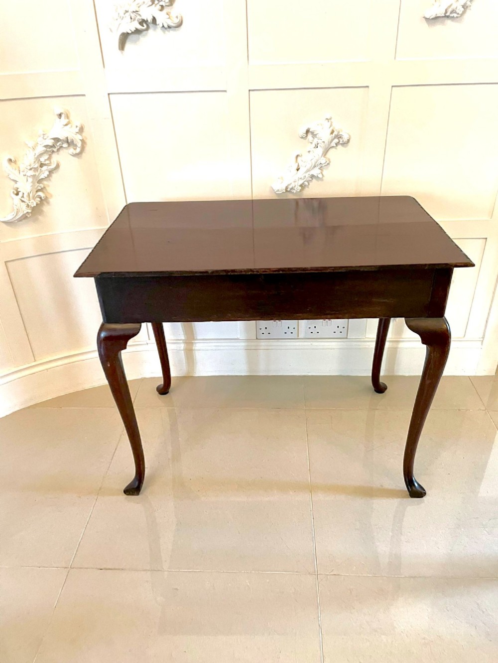 A George III mahogany side table featuring a rectangular top with carved moulding, a long drawer with brass handles, and cabriole legs. View XIV