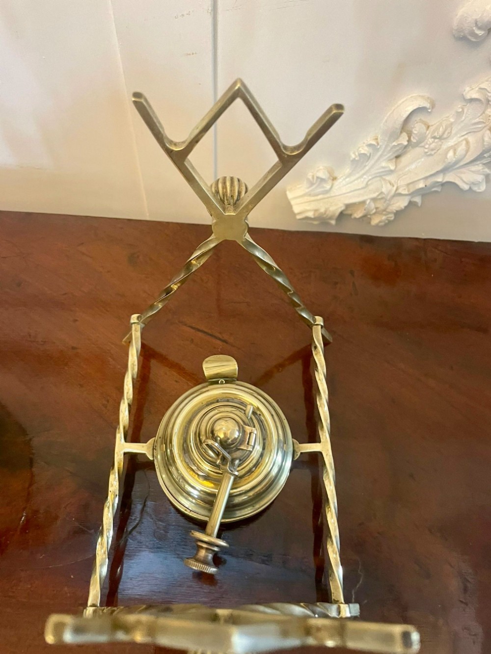 An antique Victorian brass spirit kettle featuring floral engravings, an ebonised wooden handle, and a matching brass stand with a spirit burner. View III