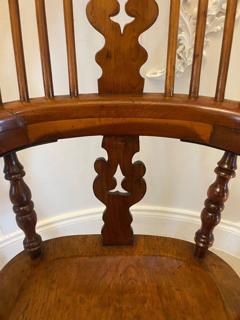 An antique Victorian yew wood Windsor armchair featuring a hoop back, spindle backrest with a central pierced splat, broad arms, and turned legs. View II