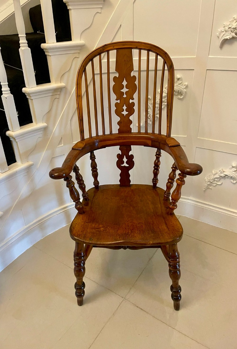 An antique Victorian yew wood Windsor armchair featuring a hoop back, spindle backrest with a central pierced splat, broad arms, and turned legs. View IV