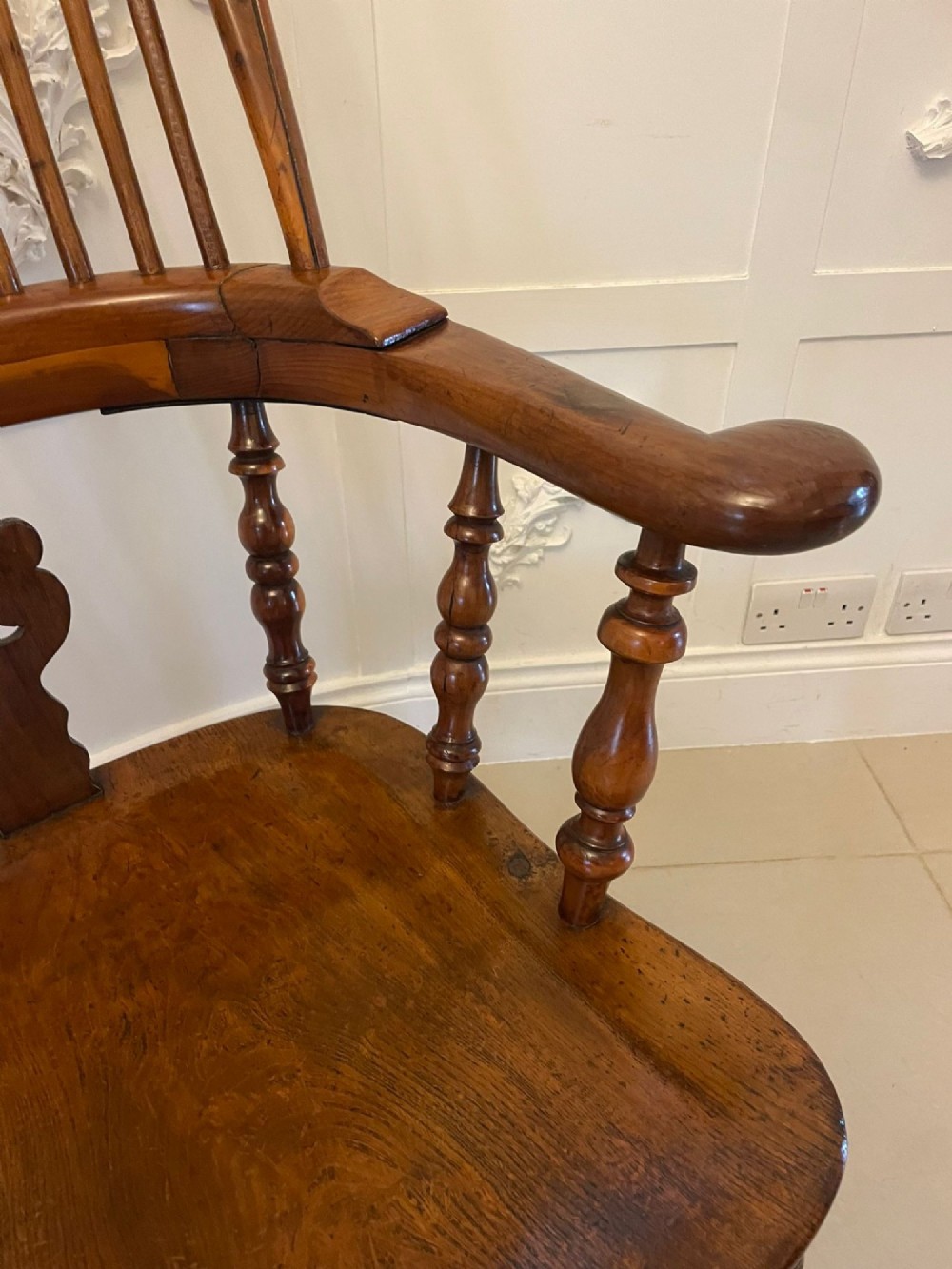 An antique Victorian yew wood Windsor armchair featuring a hoop back, spindle backrest with a central pierced splat, broad arms, and turned legs. View VI