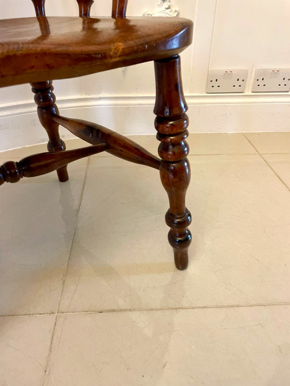 An antique Victorian yew wood Windsor armchair featuring a hoop back, spindle backrest with a central pierced splat, broad arms, and turned legs. View VII
