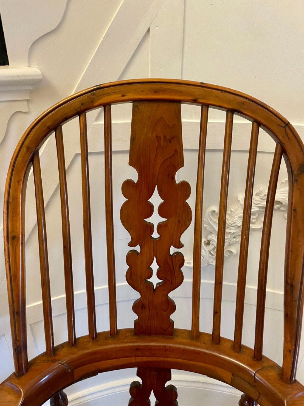 An antique Victorian yew wood Windsor armchair featuring a hoop back, spindle backrest with a central pierced splat, broad arms, and turned legs. View VIII