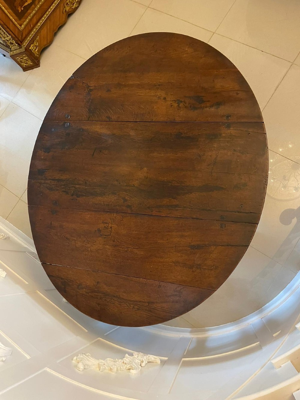 A dark oak seventeenth-century gateleg dining table with folded drop leaves, barley twist legs, and sturdy base stretchers. View II