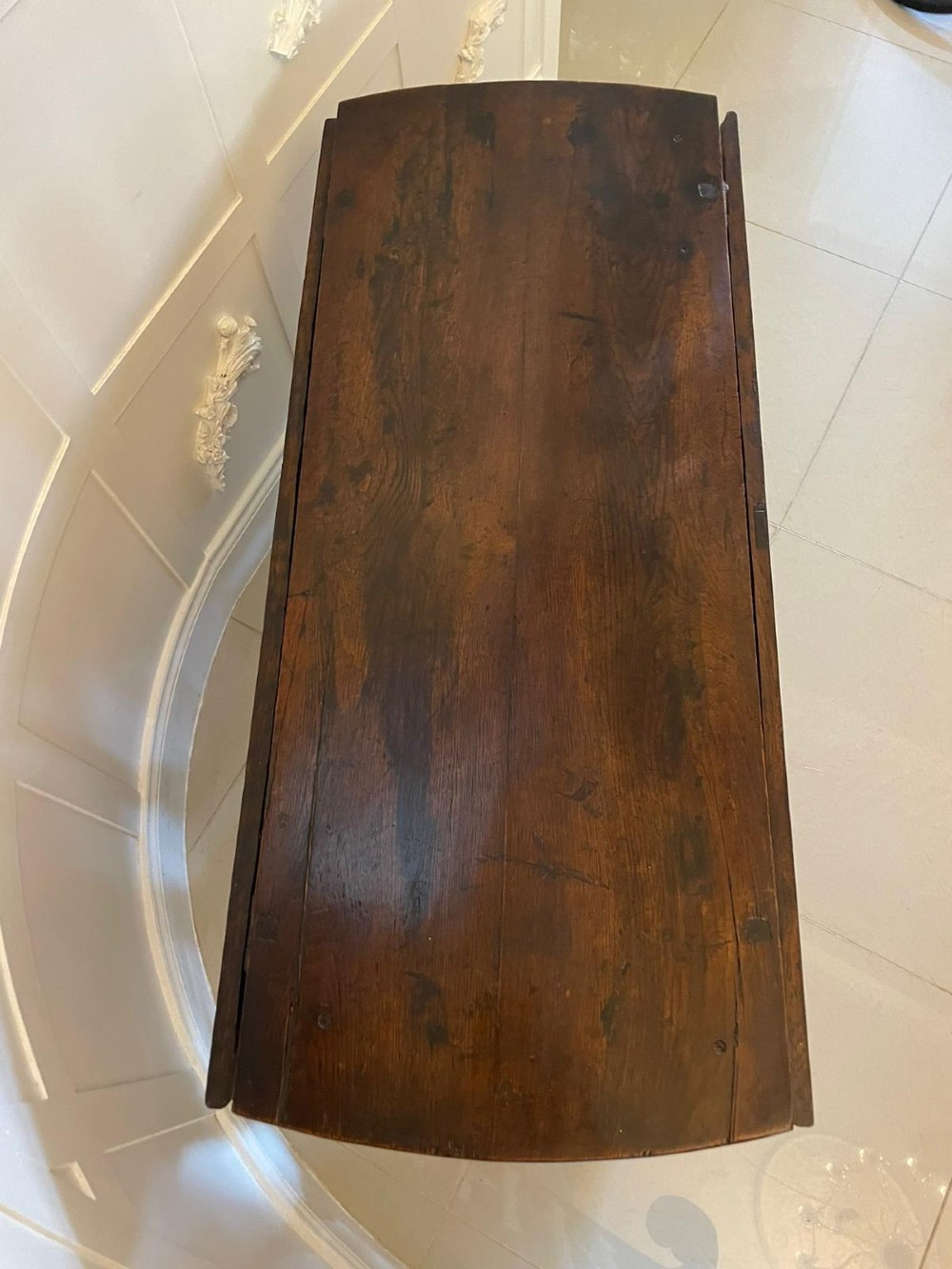 A dark oak seventeenth-century gateleg dining table with folded drop leaves, barley twist legs, and sturdy base stretchers. View VI