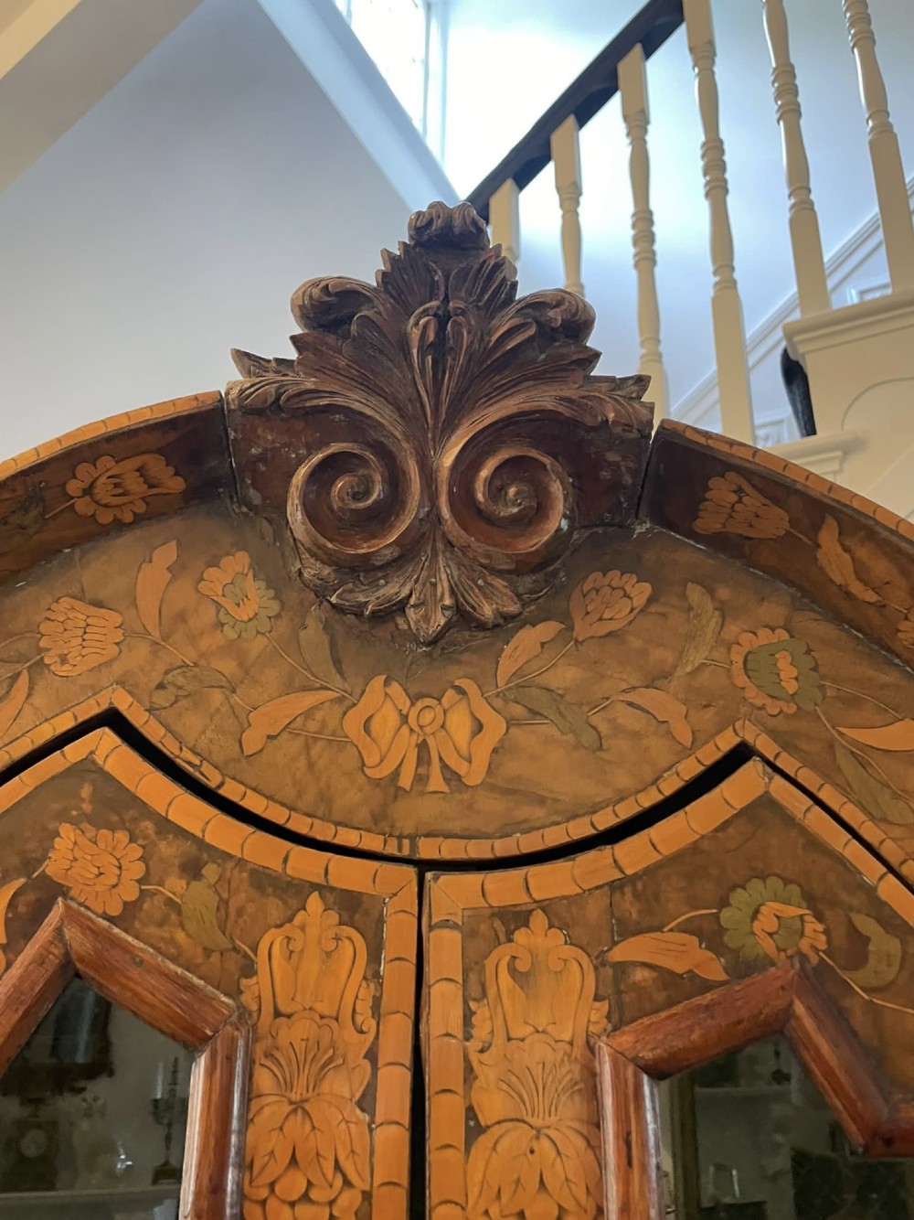 An antique Dutch burr walnut display cabinet featuring elaborate floral marquetry inlay, glazed upper doors, a serpentine three-drawer base, and carved claw feet. View XI