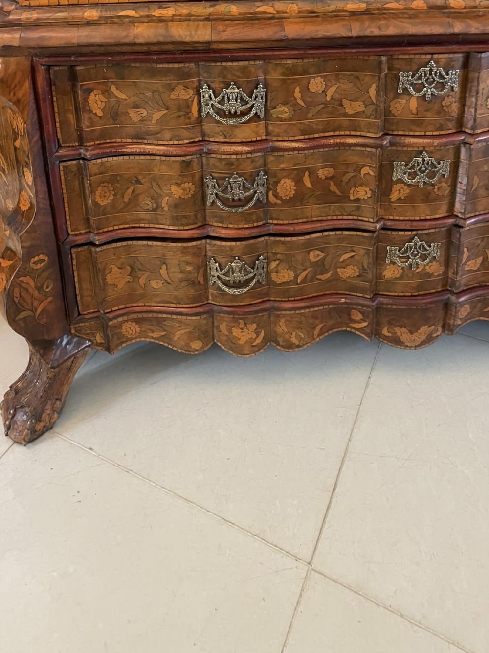 An antique Dutch burr walnut display cabinet featuring elaborate floral marquetry inlay, glazed upper doors, a serpentine three-drawer base, and carved claw feet. View XIII