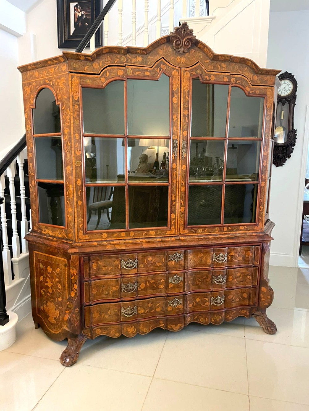 An antique Dutch burr walnut display cabinet featuring elaborate floral marquetry inlay, glazed upper doors, a serpentine three-drawer base, and carved claw feet. View XIV