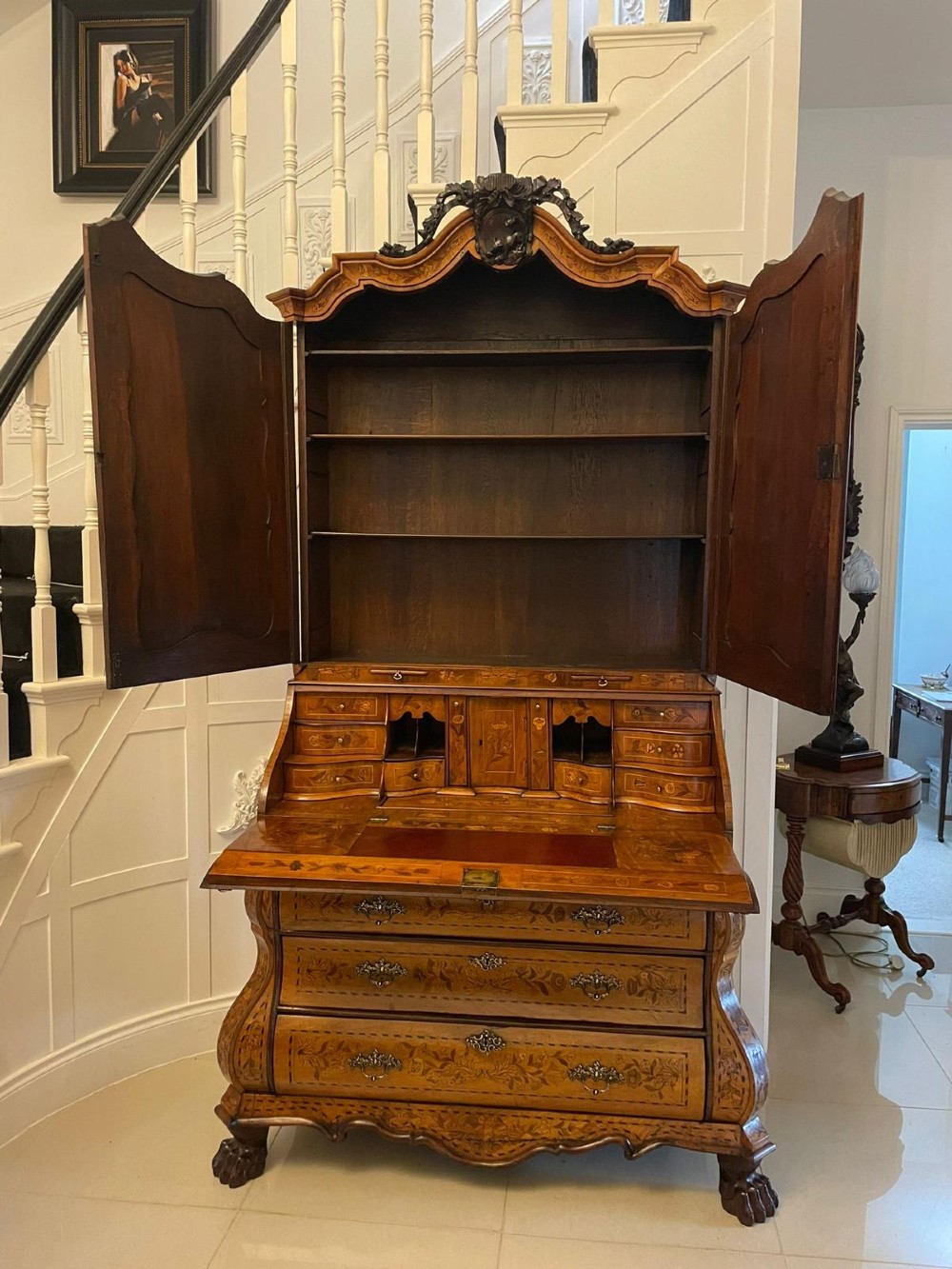 An 18th-century Dutch burr walnut bureau bookcase featuring intricate floral marquetry, a bombe lower drawer section, a fall-front desk slope, and an arched twin-door upper cabinet supported on claw feet. View III