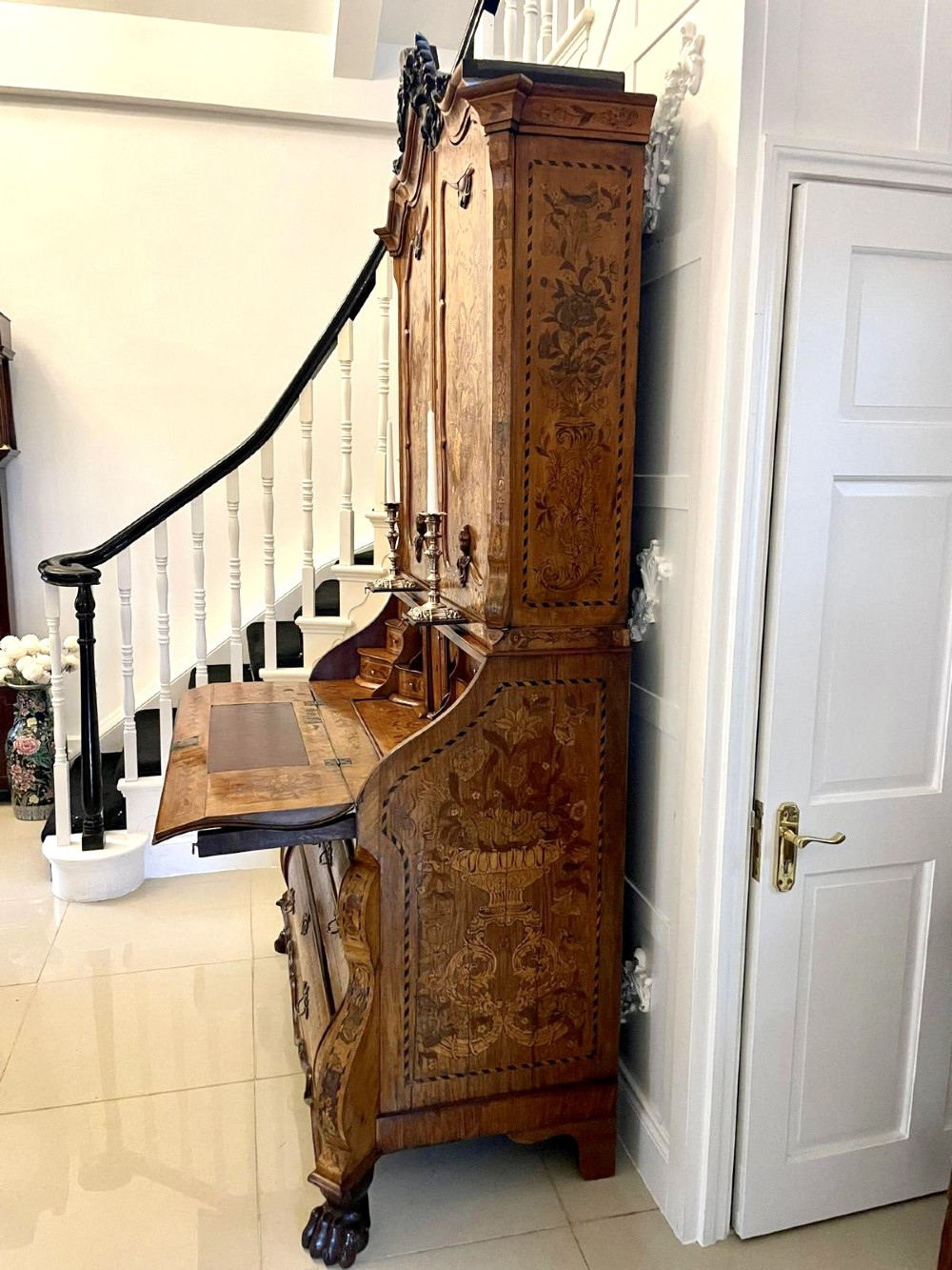 An 18th-century Dutch burr walnut bureau bookcase featuring intricate floral marquetry, a bombe lower drawer section, a fall-front desk slope, and an arched twin-door upper cabinet supported on claw feet. View IX