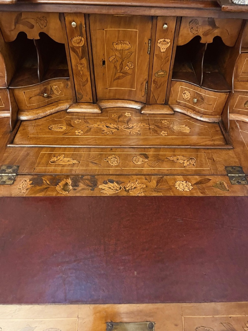 An 18th-century Dutch burr walnut bureau bookcase featuring intricate floral marquetry, a bombe lower drawer section, a fall-front desk slope, and an arched twin-door upper cabinet supported on claw feet. View XI