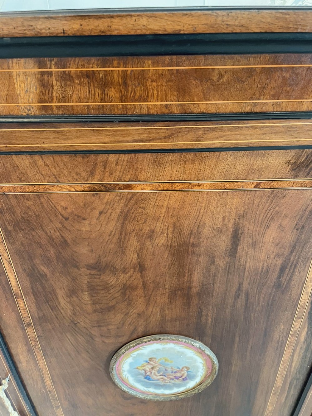 A Victorian dark walnut floor-standing corner cabinet featuring fine marquetry inlay and a central oval hand-painted porcelain plaque. View III