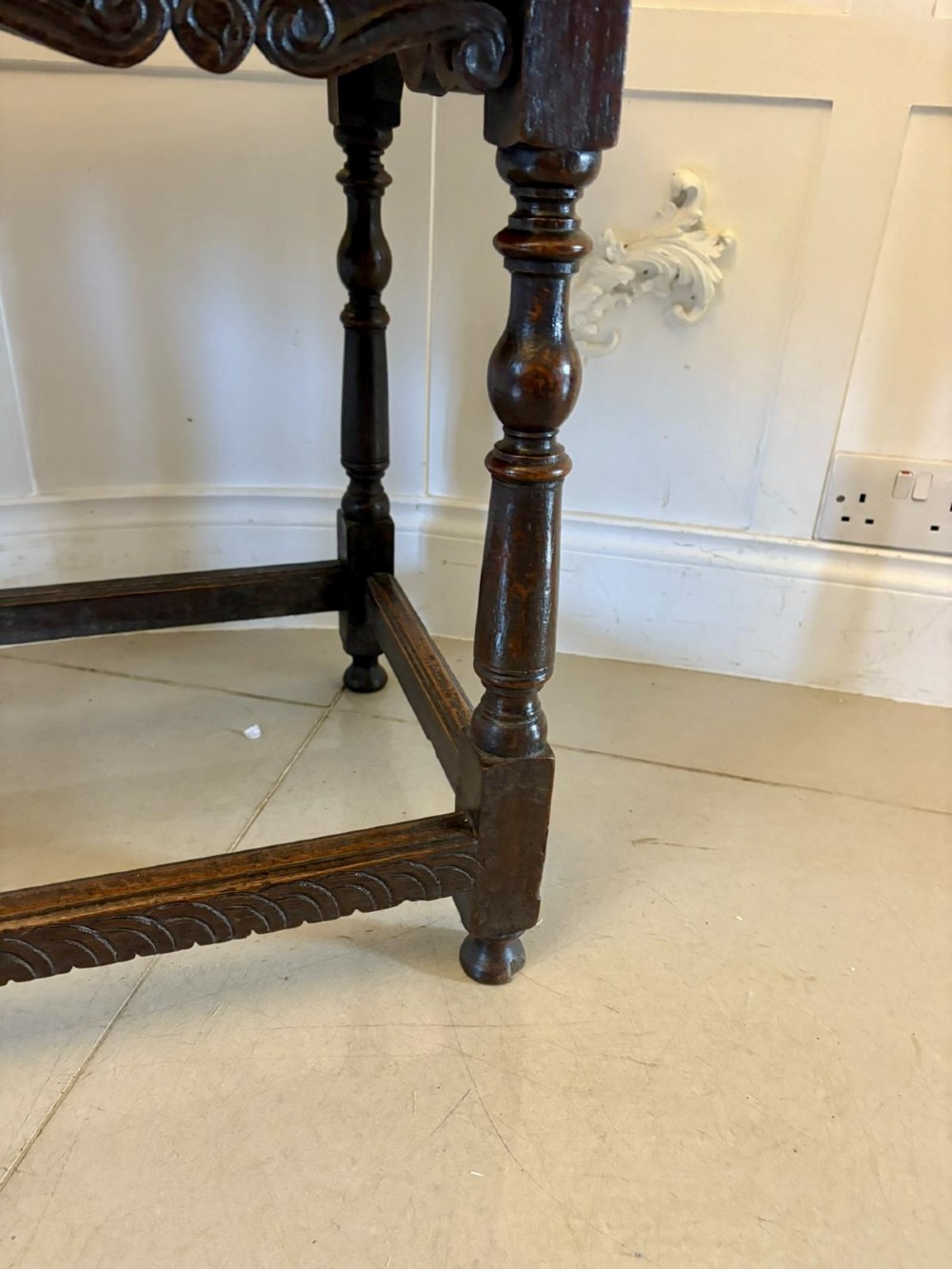 An 18th-century dark oak side table featuring a carved frieze drawer, turned legs, and a rectangular stretcher base. View IV