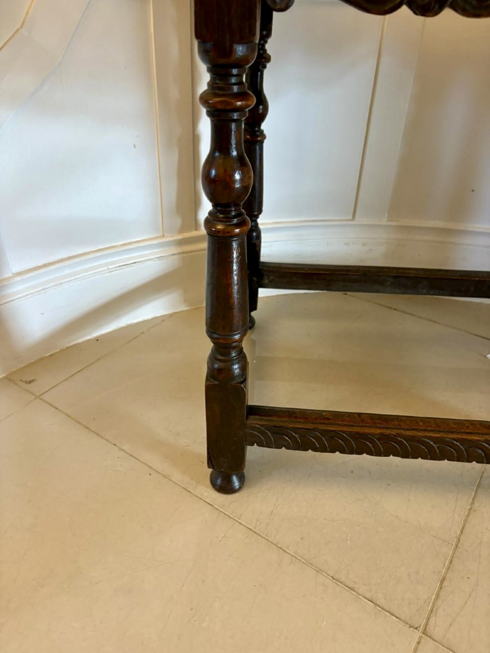 An 18th-century dark oak side table featuring a carved frieze drawer, turned legs, and a rectangular stretcher base. View VII