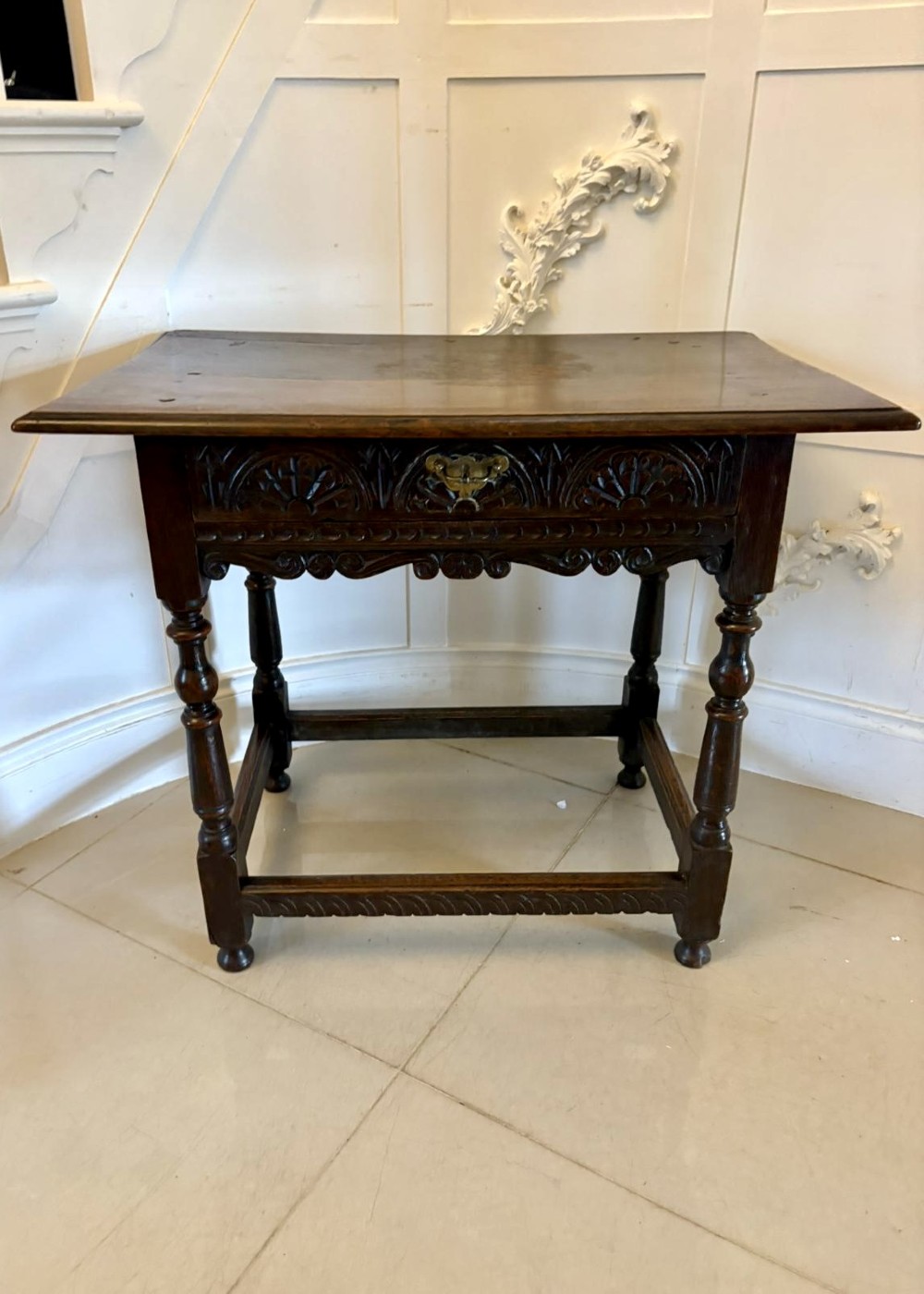 An 18th-century dark oak side table featuring a carved frieze drawer, turned legs, and a rectangular stretcher base. View IX