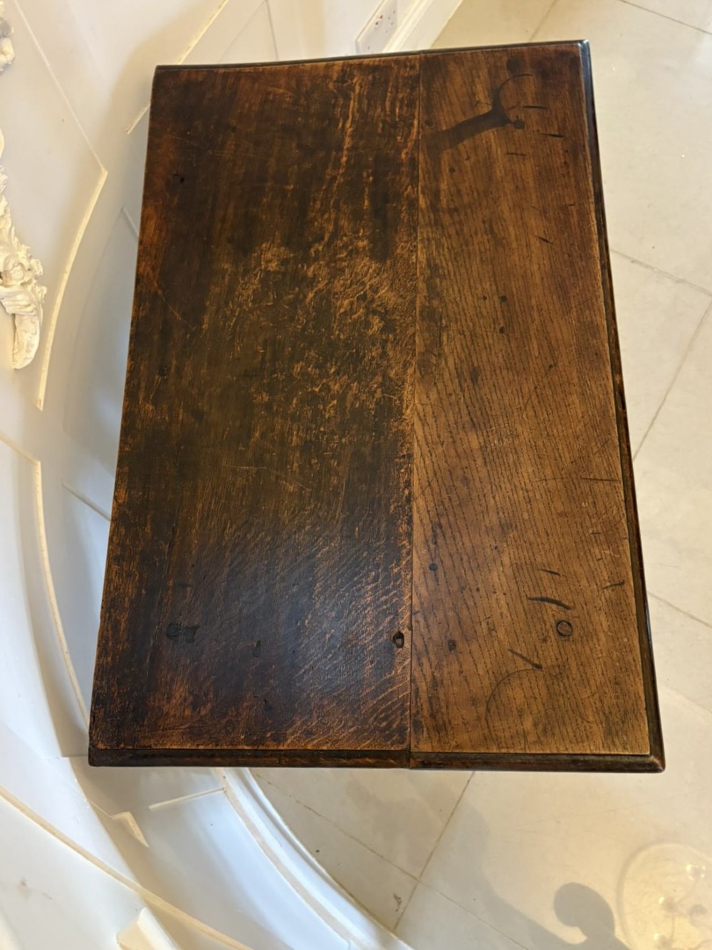 An 18th-century dark oak side table featuring a carved frieze drawer, turned legs, and a rectangular stretcher base. View X