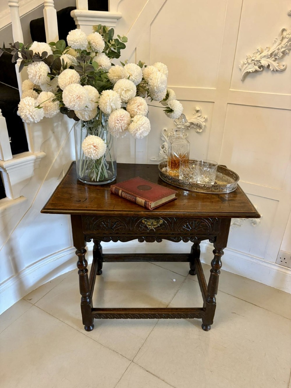 An 18th-century dark oak side table featuring a carved frieze drawer, turned legs, and a rectangular stretcher base. View XII