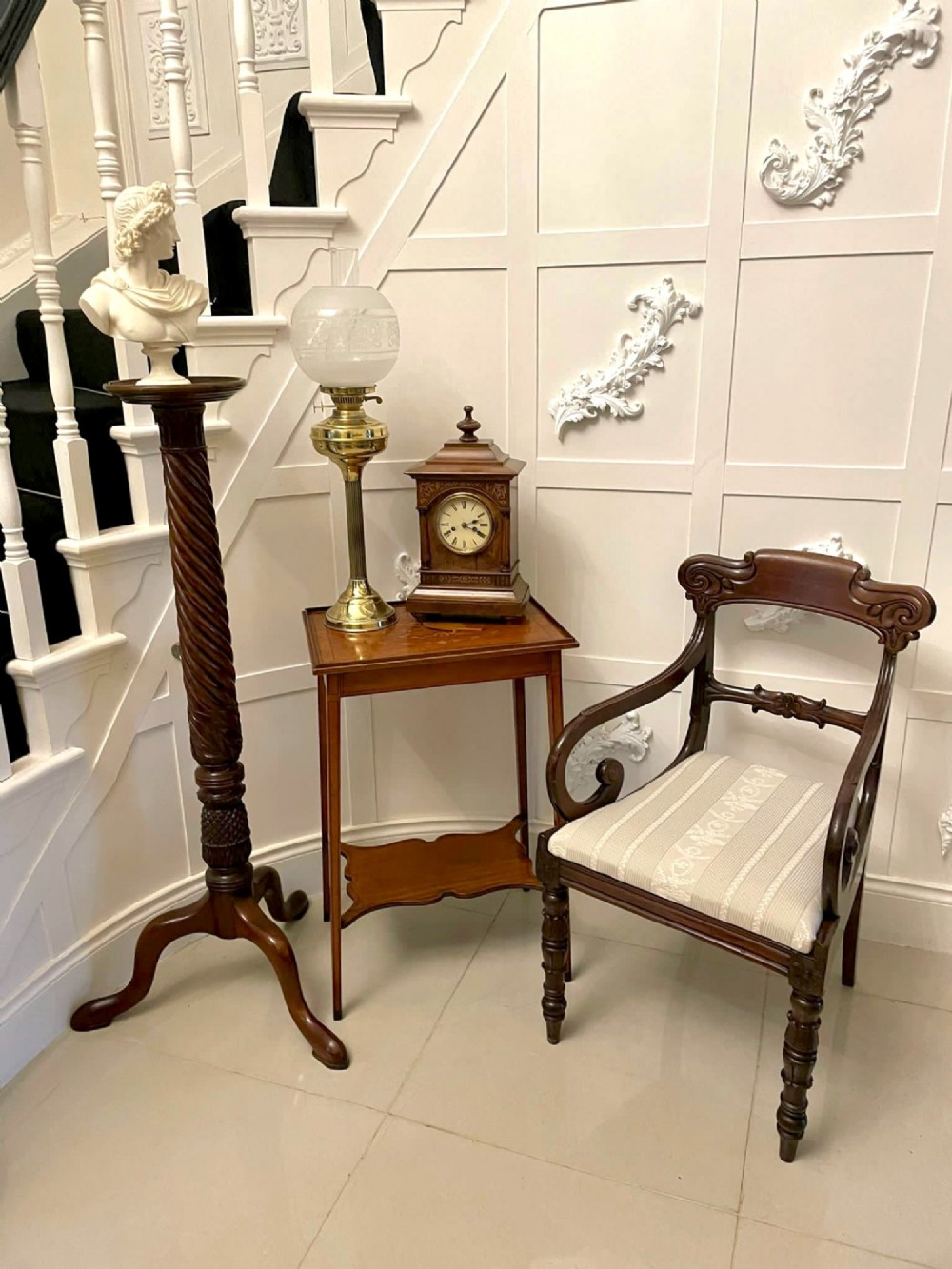 An Edwardian rectangular satinwood inlaid side table featuring a raised tray top with central musical instrument marquetry, slender square tapered legs, and a shaped undertier shelf. View V