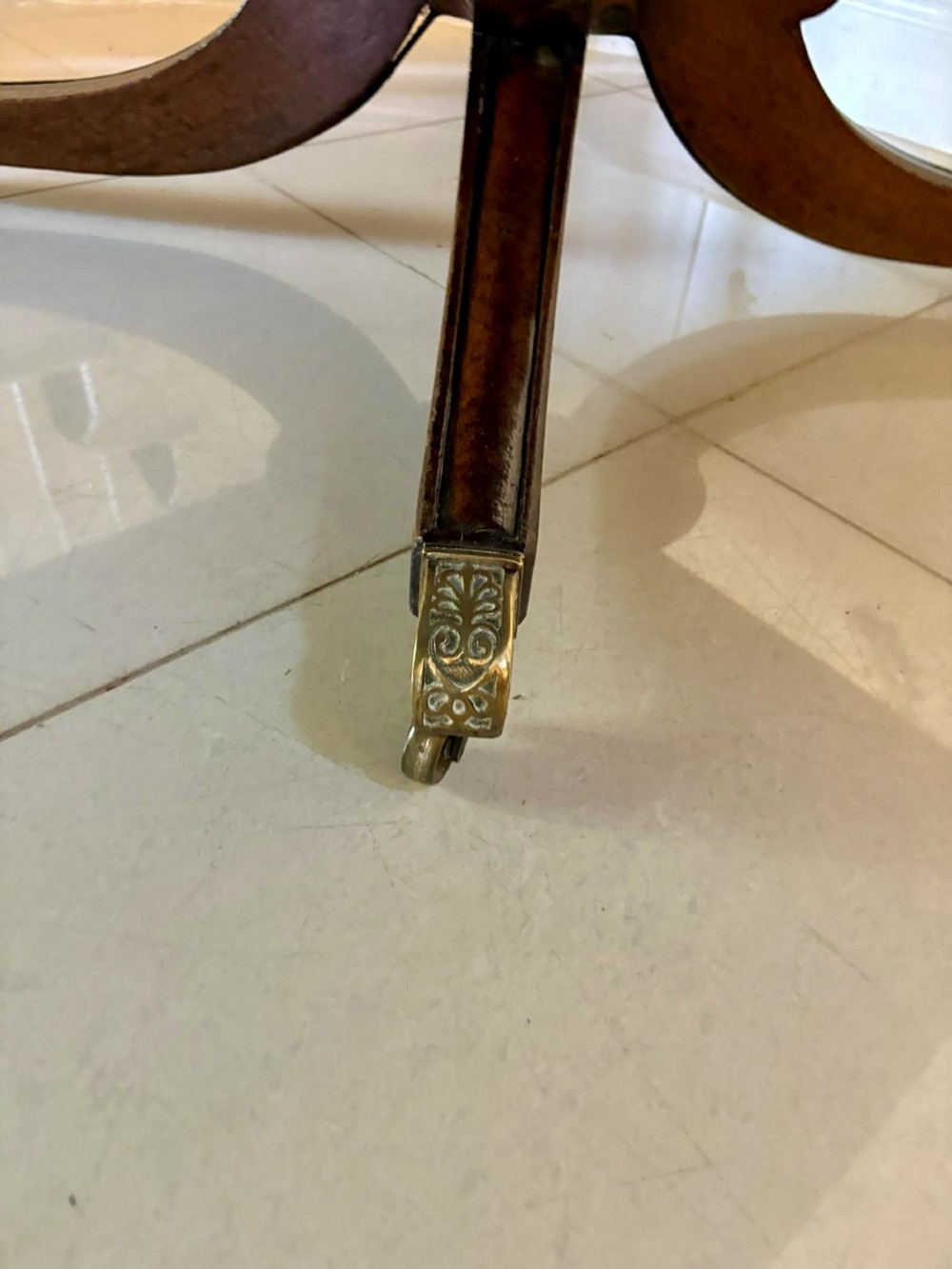 A large George III figured mahogany twin-pillar extending dining table with splayed tripod legs ending in brass castors. View IX