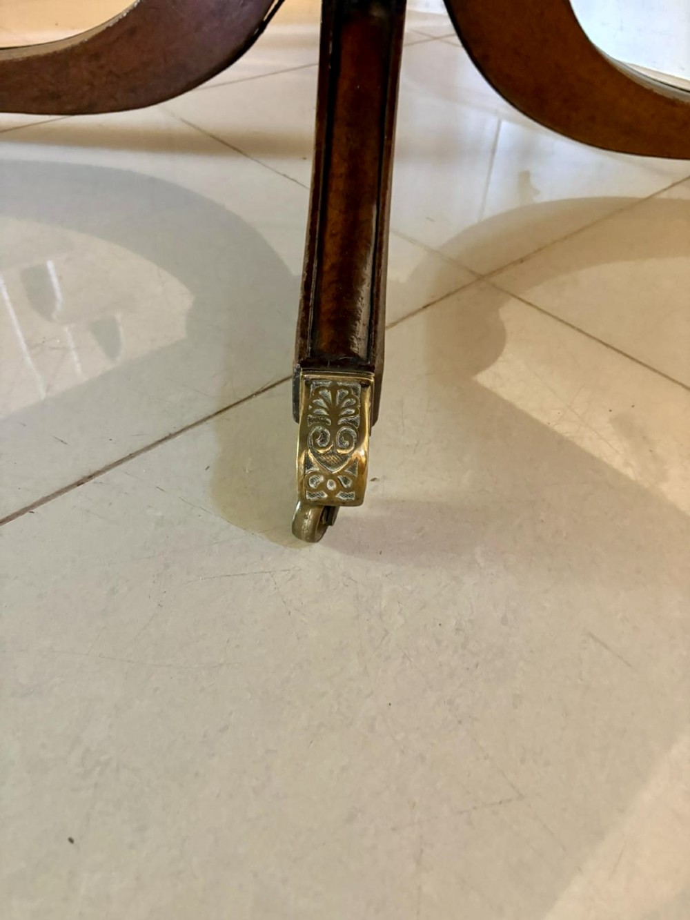 A large George III figured mahogany twin-pillar extending dining table with splayed tripod legs ending in brass castors. View XI