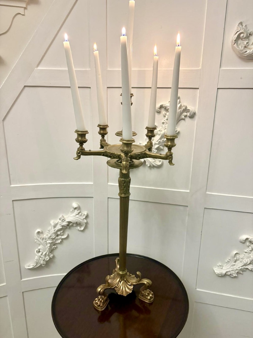 An antique Victorian gilt brass six-light candelabrum featuring a fluted central stem, acanthus leaf motifs, and paw feet. View III