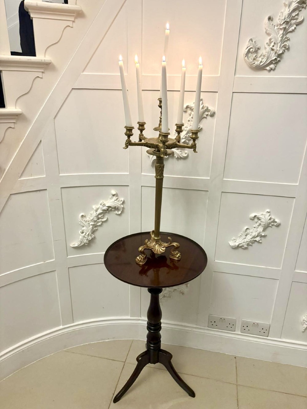 An antique Victorian gilt brass six-light candelabrum featuring a fluted central stem, acanthus leaf motifs, and paw feet. View IV