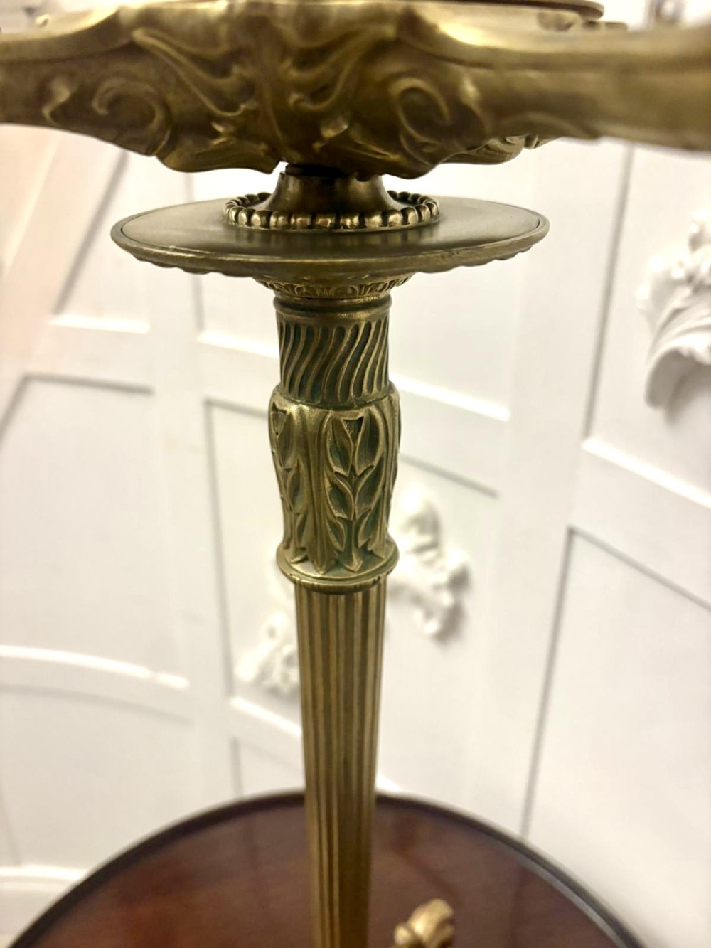 An antique Victorian gilt brass six-light candelabrum featuring a fluted central stem, acanthus leaf motifs, and paw feet. View VI