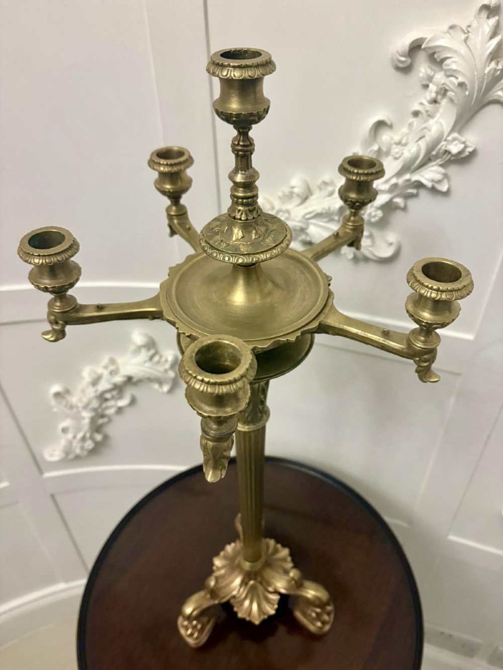 An antique Victorian gilt brass six-light candelabrum featuring a fluted central stem, acanthus leaf motifs, and paw feet. View VIII