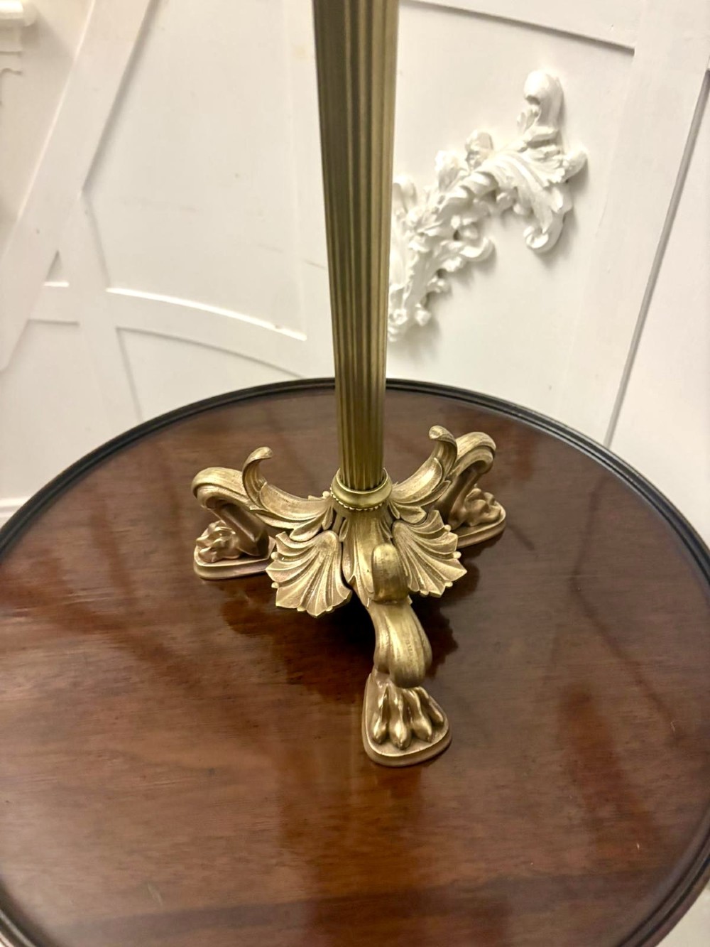 An antique Victorian gilt brass six-light candelabrum featuring a fluted central stem, acanthus leaf motifs, and paw feet. View IX