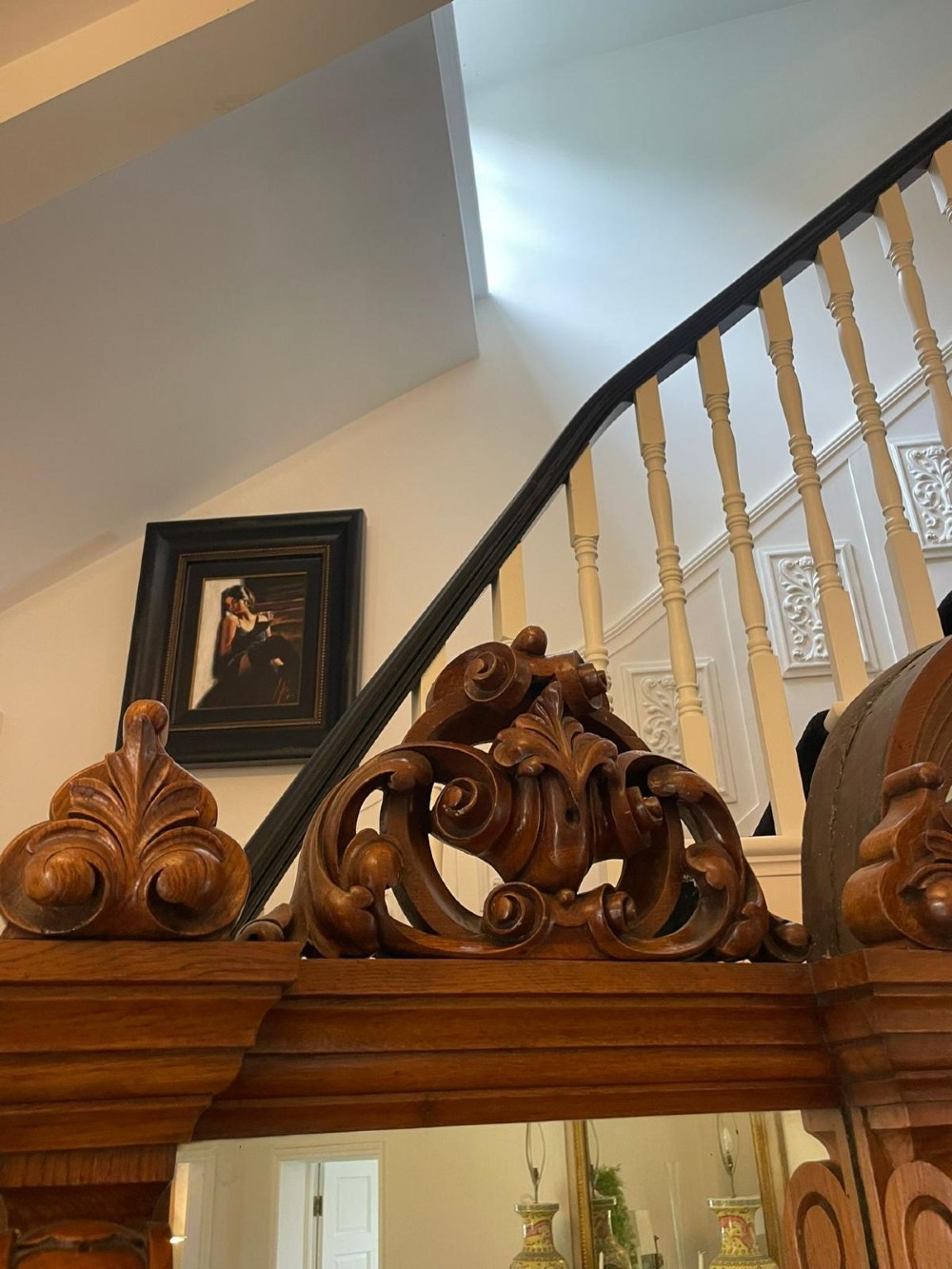 A large Victorian carved oak sideboard featuring three upper mirror panels, intricate grape cluster wood carvings, and a pedestal base. View XI