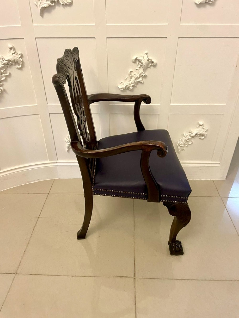 A set of carved mahogany dining chairs featuring pierced back splats, ball and claw feet, and purple leather seats. View III