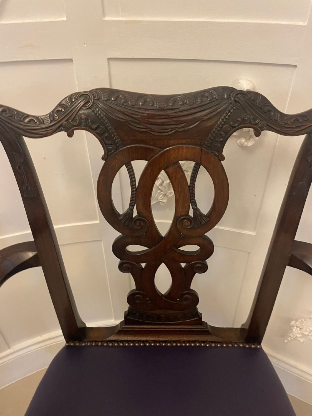 A set of carved mahogany dining chairs featuring pierced back splats, ball and claw feet, and purple leather seats. View VI
