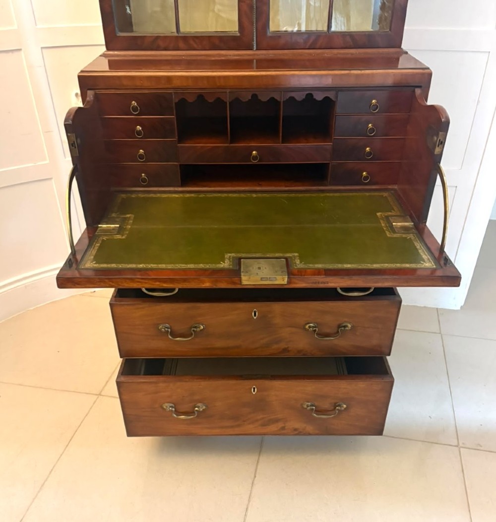 A tall Georgian mahogany secretaire bookcase featuring an upper cabinet with astragal glazed doors and a lower chest of drawers with brass handles. View XI