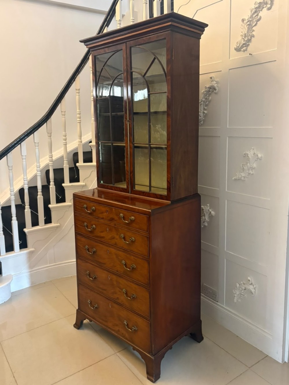 A tall Georgian mahogany secretaire bookcase featuring an upper cabinet with astragal glazed doors and a lower chest of drawers with brass handles. View XIII