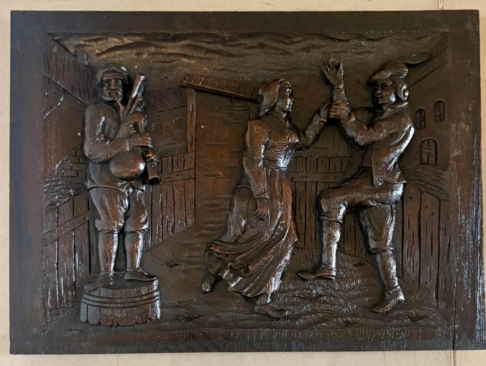 A set of five square dark carved oak wall panels featuring detailed bas-relief scenes of figures in traditional Flemish tavern settings. View VIII