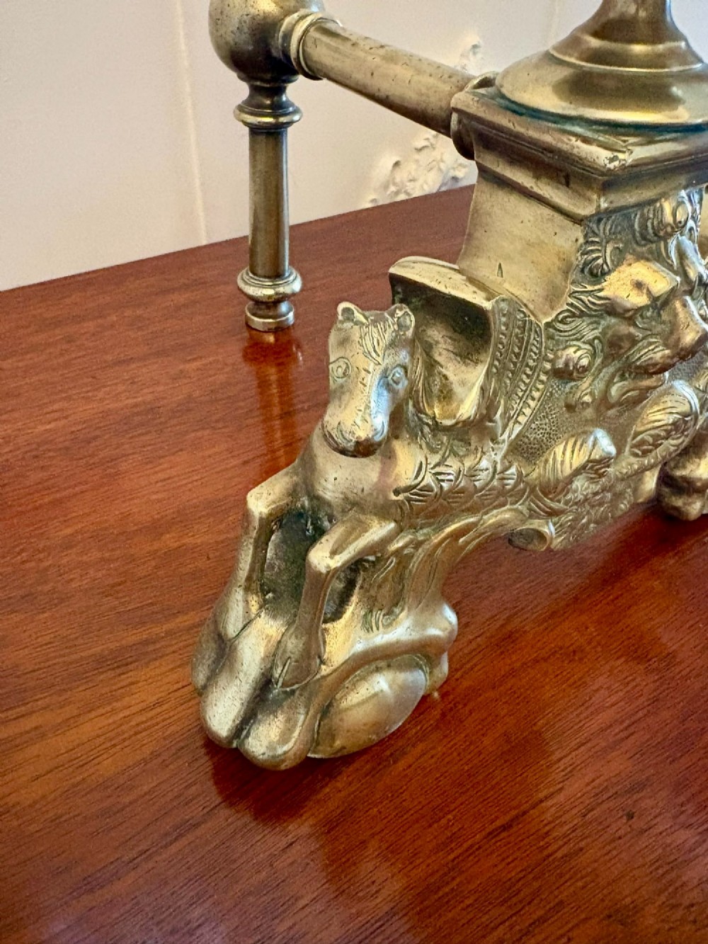 A pair of ornate Victorian cast brass fire dogs featuring spiral-fluted finials, gadrooned central urns, and mythological horse motifs on the base. View VI