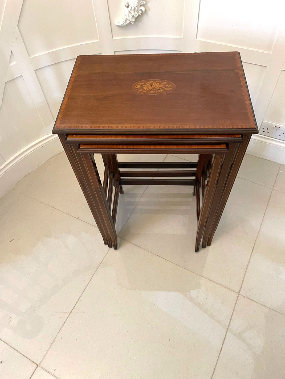 A set of three graduated mahogany nesting tables with central oval satinwood inlays and slender square legs. View III