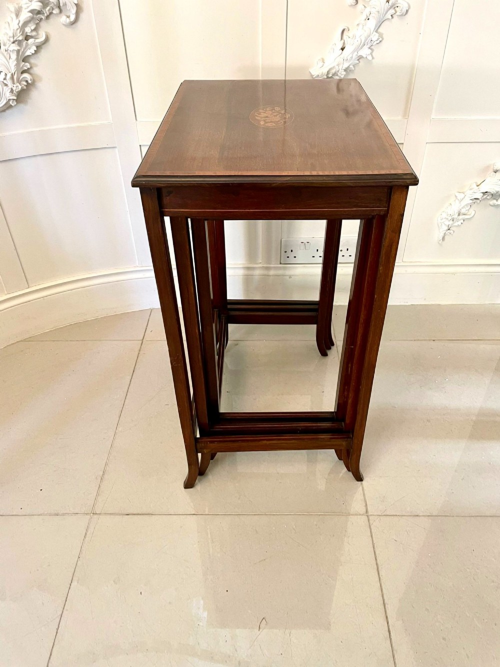 A set of three graduated mahogany nesting tables with central oval satinwood inlays and slender square legs. View VIII
