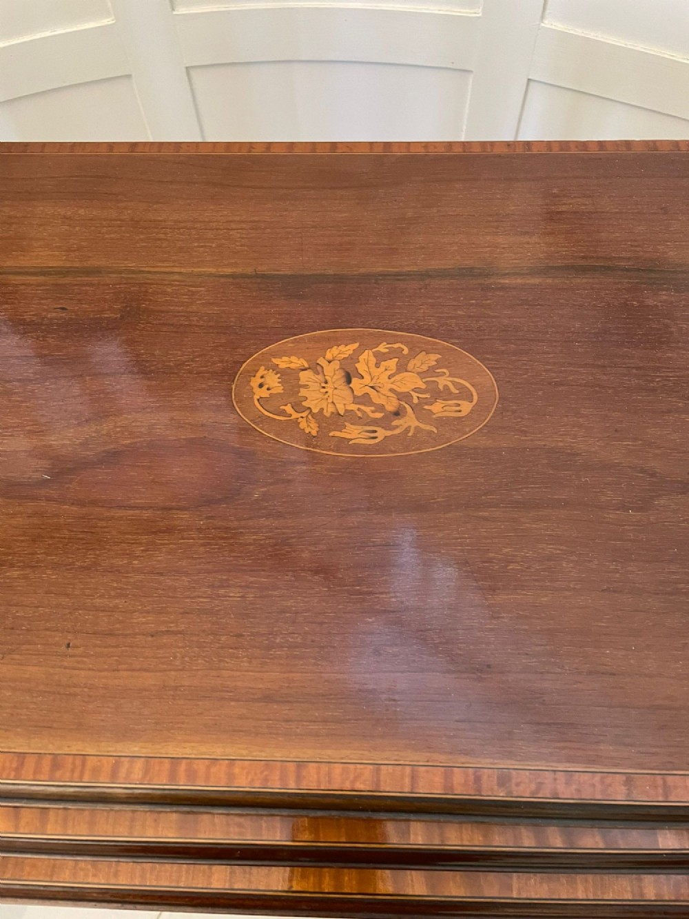 A set of three graduated mahogany nesting tables with central oval satinwood inlays and slender square legs. View IX