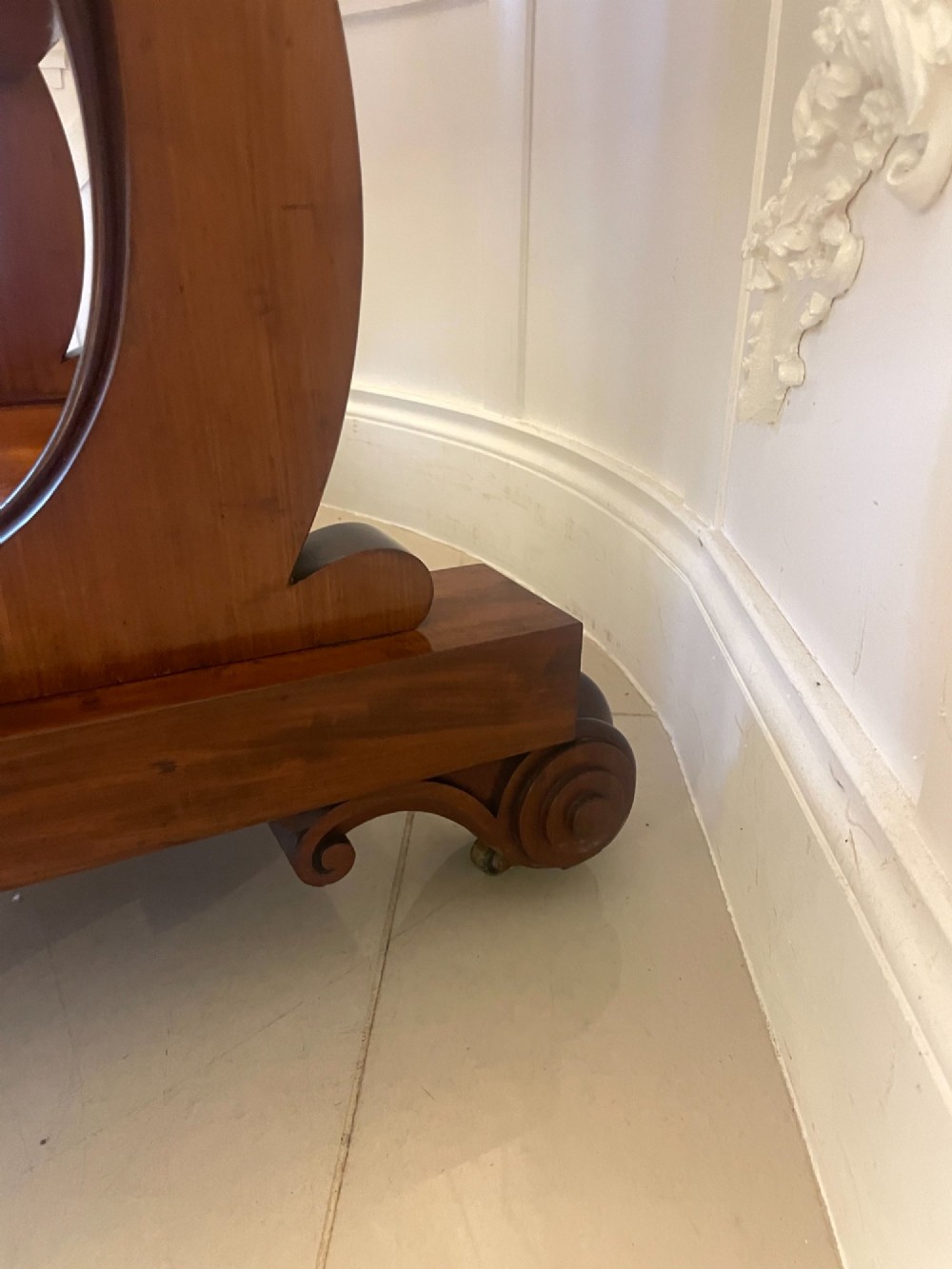 A Victorian mahogany cheval mirror featuring a rectangular swinging frame mounted between curved upright supports on a solid plinth base. View III