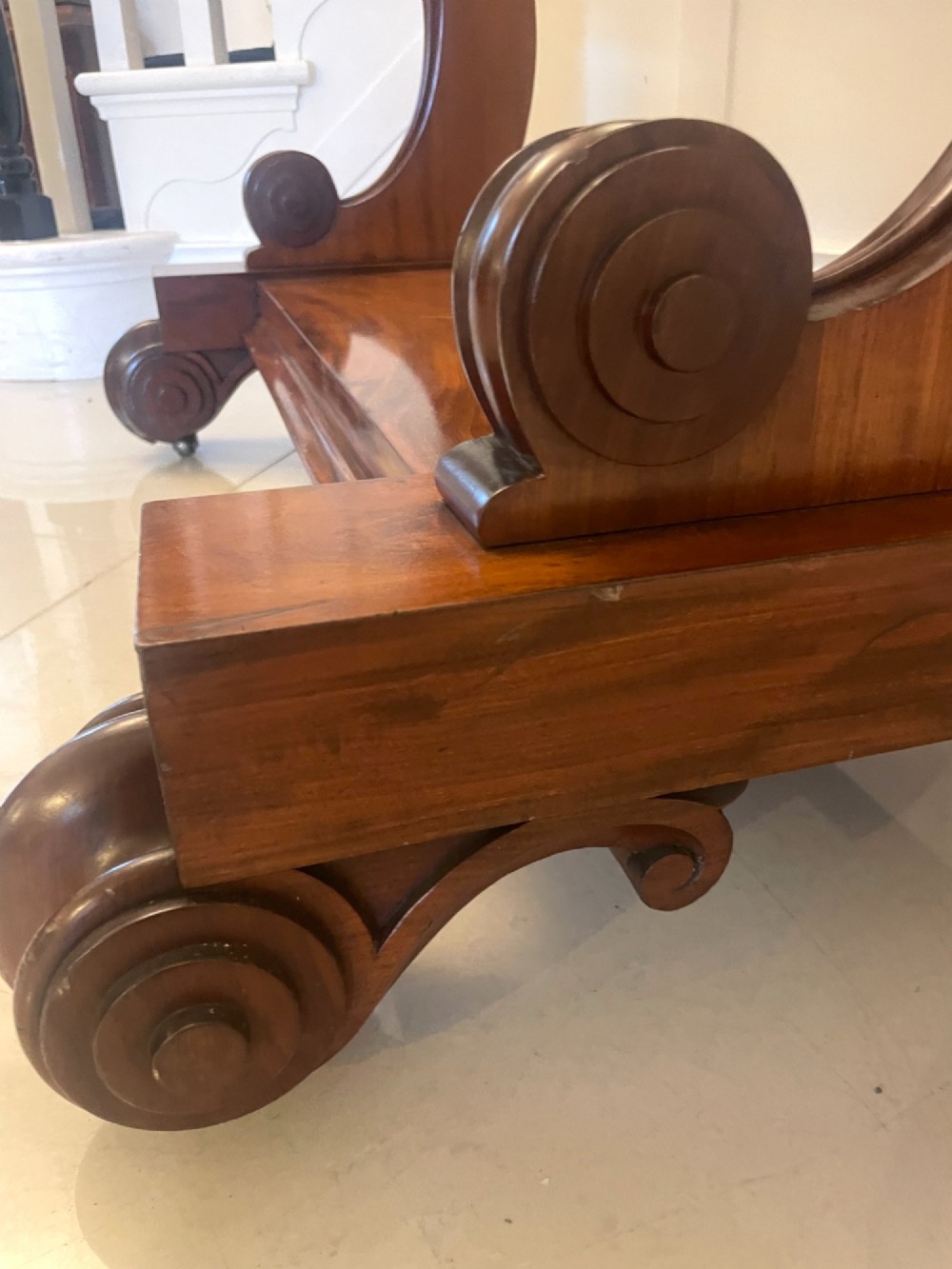 A Victorian mahogany cheval mirror featuring a rectangular swinging frame mounted between curved upright supports on a solid plinth base. View IV