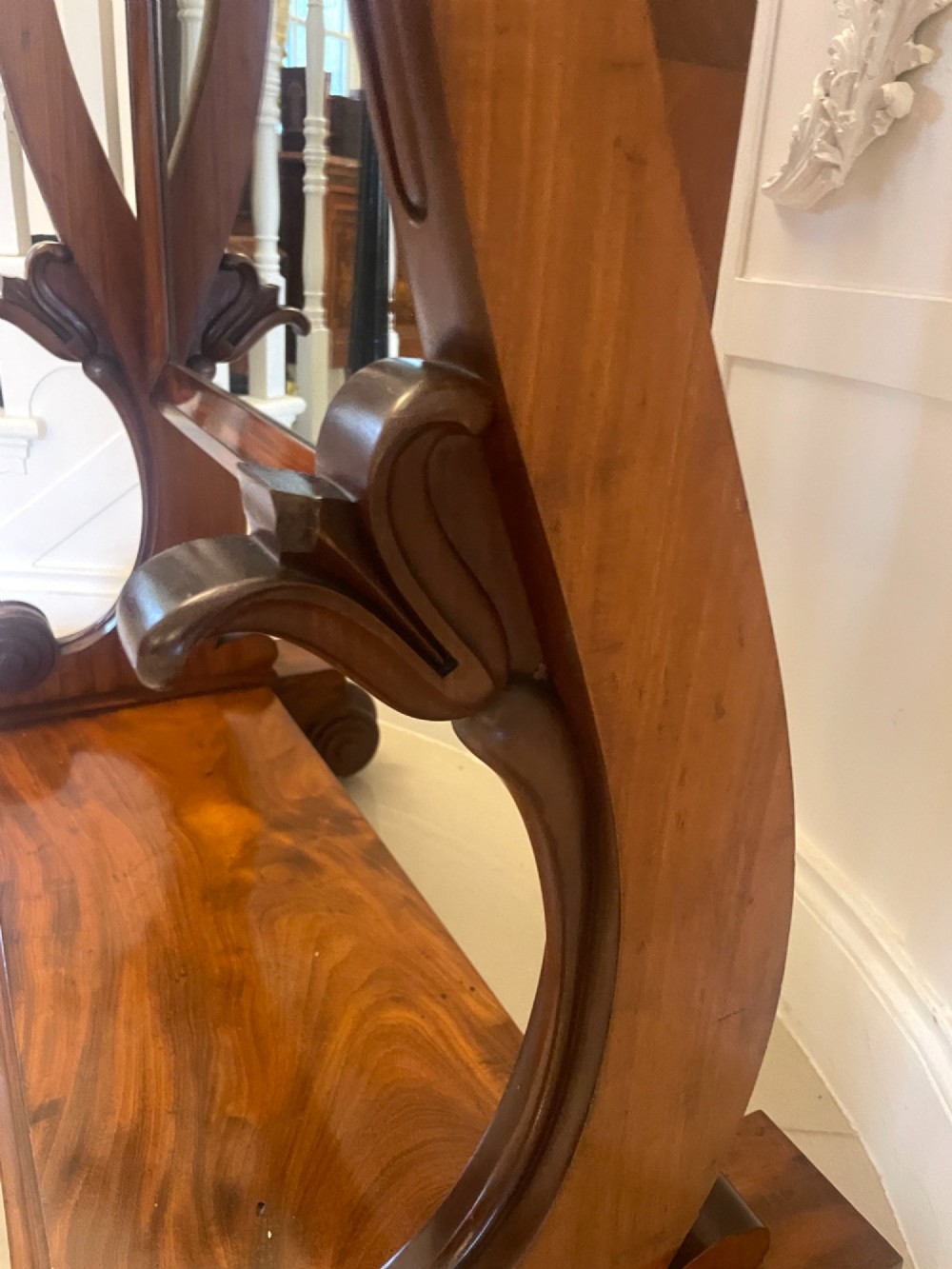 A Victorian mahogany cheval mirror featuring a rectangular swinging frame mounted between curved upright supports on a solid plinth base. View V