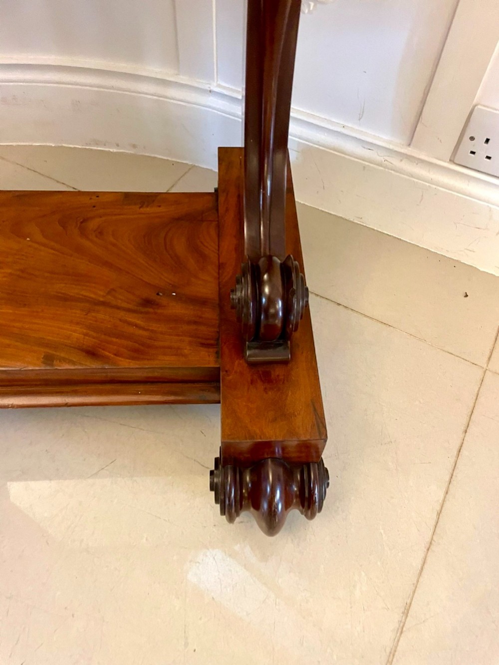 A Victorian mahogany cheval mirror featuring a rectangular swinging frame mounted between curved upright supports on a solid plinth base. View VII