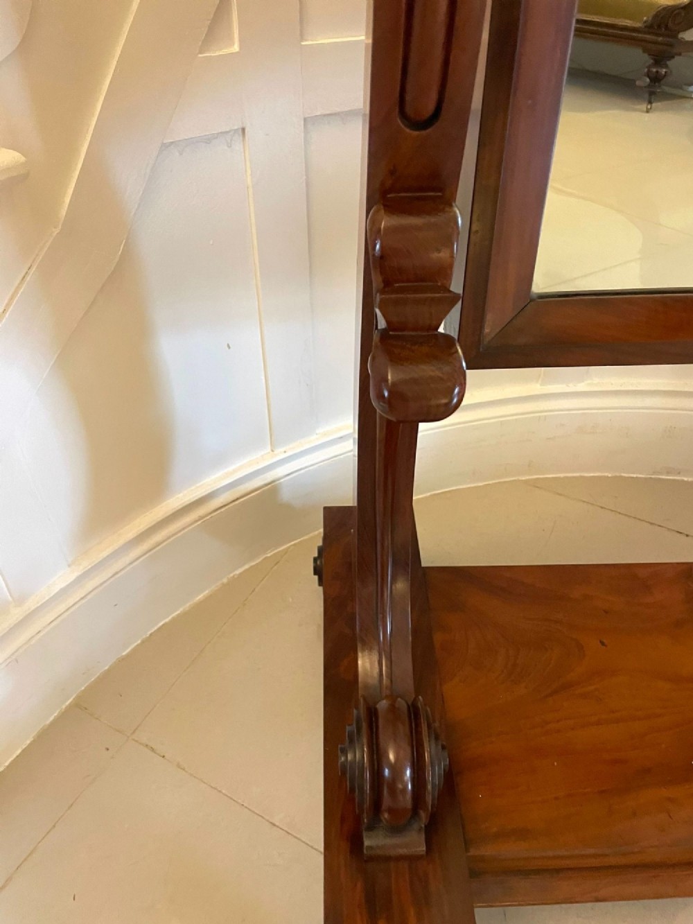 A Victorian mahogany cheval mirror featuring a rectangular swinging frame mounted between curved upright supports on a solid plinth base. View IX