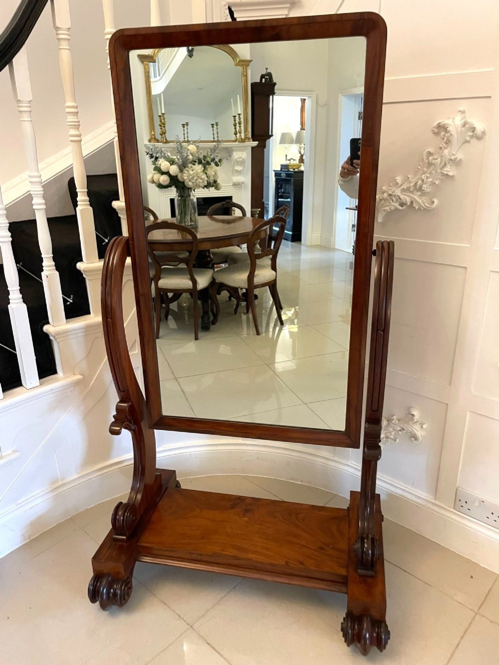A Victorian mahogany cheval mirror featuring a rectangular swinging frame mounted between curved upright supports on a solid plinth base. View XIII