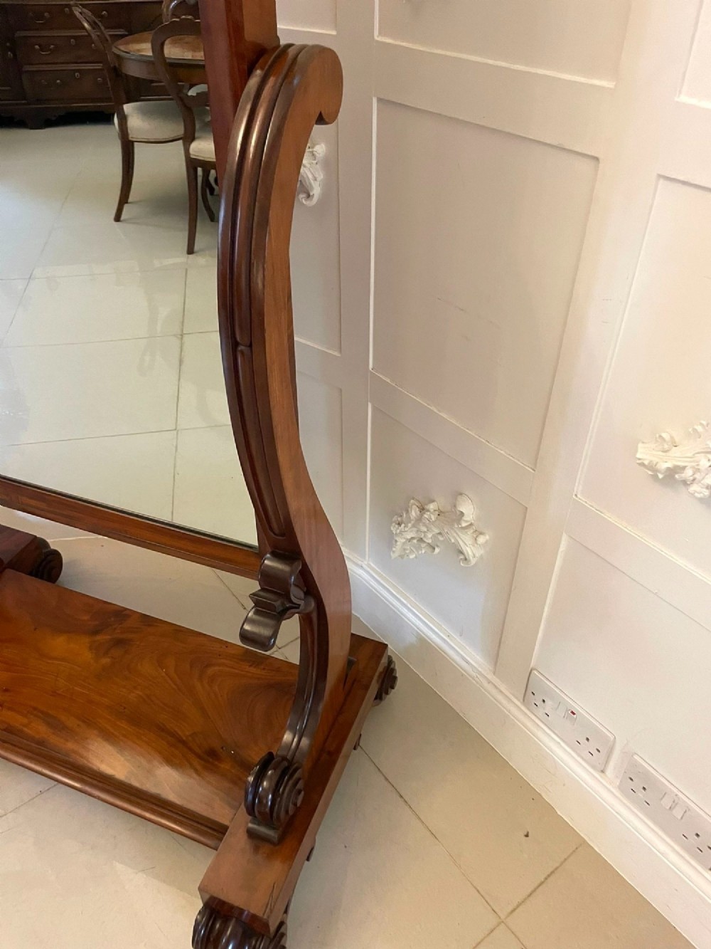 A Victorian mahogany cheval mirror featuring a rectangular swinging frame mounted between curved upright supports on a solid plinth base. View XIV