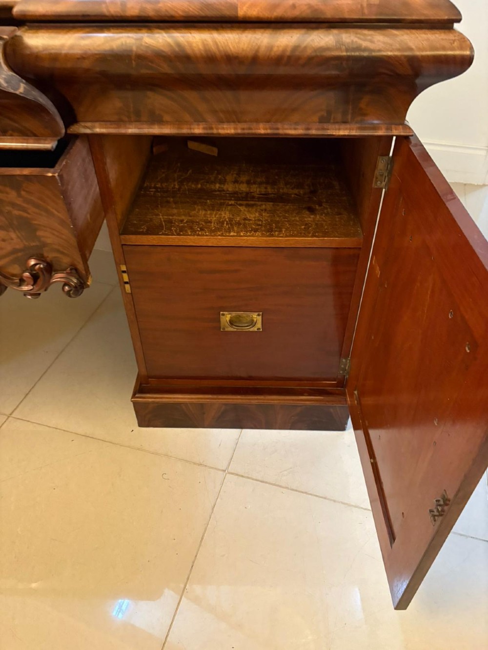 An antique Victorian carved mahogany sideboard featuring twin pedestal bases with carved scroll mouldings and a large arched mirror-backed top frame. View III
